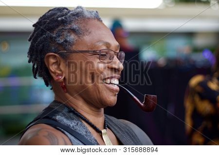 21 July 2018 - Africa Utopia, Southbank, London: Black Woman Smoking Pipe