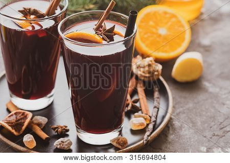 Hot Mulled Wine With Spices, Apple And Orange On Chrictmas Background. Copy Space.