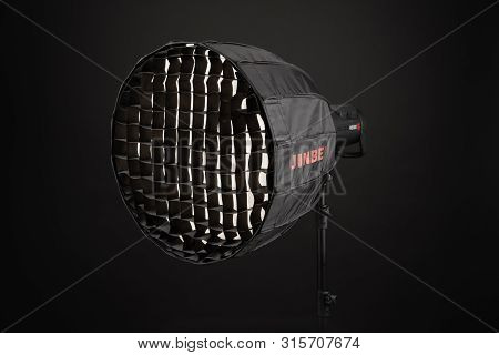 A Modern Electric Saturated Black Octobox On A Tripod. A Huge Octobox Over Black Background. Equipme