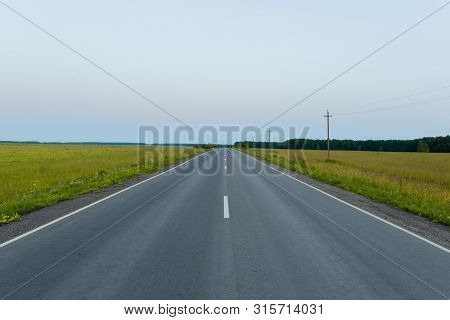 Direct Asphalt Road In The Middle Of A Wheat Field With Markings