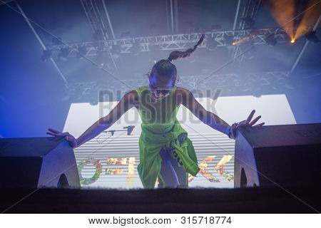 Woman Performer Singing On Stage