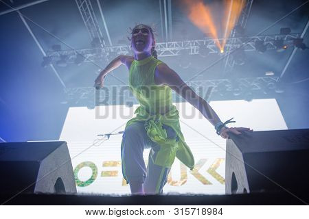 Woman Performer Singing On Stage