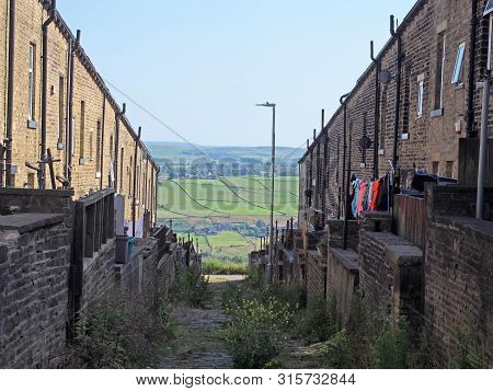 A Typical Northern Back Alley In West Yorkshire With Yards And Washing Lines Between Streets Of Old 