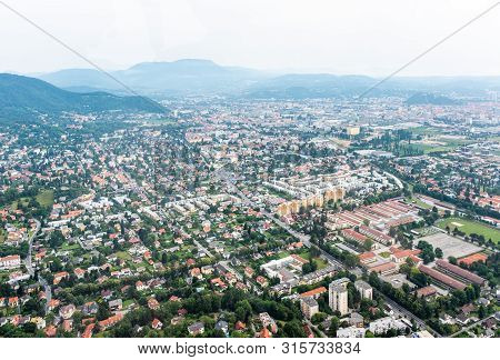 Aerial View Of City Graz From Helicopter Drone With Districts Eggenberg And Wezelsdorf On A Cloudy S