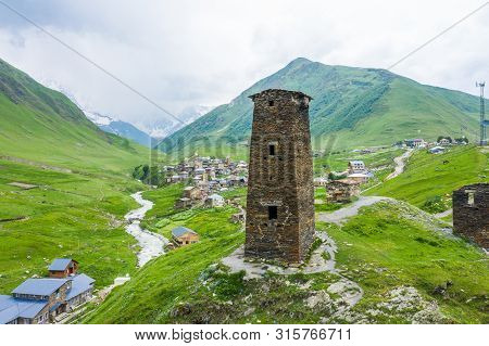 View Of The Ushguli Village At The Foot Of Mt. Shkhara. Picturesque And Gorgeous Scene. Rock Tower T