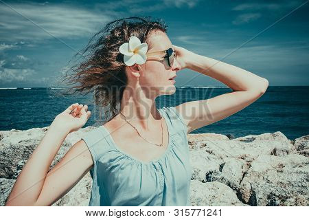 Female Tourist Enjoying Sunny Day On Beach. Skincare Sun Protection Concept. Girl Enjoy Freedom Exot