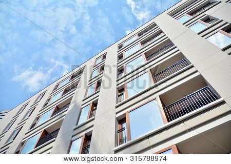 Contemporary Residential Building Exterior In The Daylight. Modern Apartment Buildings On A Sunny Da