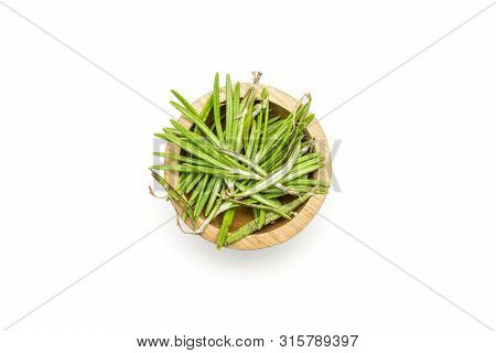 Lot Of Pieces Of Fresh Evergreen Sprig Of Rosemary In A Wooden Bowl Flatlay Isolated On White Backgr
