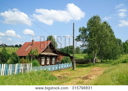 Village Street In Summer. Beautiful Traditional Log House. Village Of Visim, Sverdlovsk Region, Ural