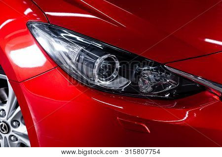 Novosibirsk, Russia - July 17, 2019:  Mazda 3, Close-up Of The Headlight, Bumper, Wheel. Photography