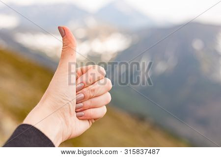 Happy Fimale Traveler Showing Thumb Up In Spring Mountains, Point Of View Shot