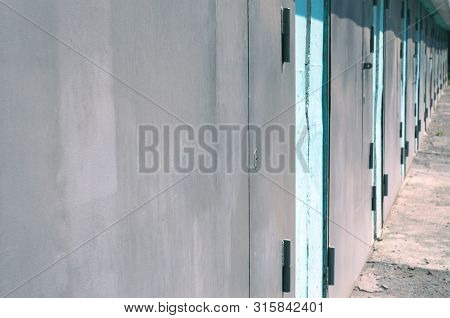 Perspective View Of Grey Doors Of Garage Units Or Self Storage Facility. Organizing Your Life Concep