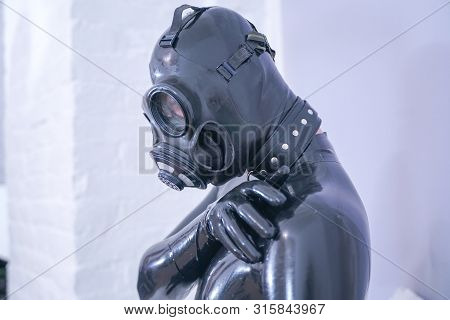 Man In The Latex Rubber Black Catsuit With Gasmask