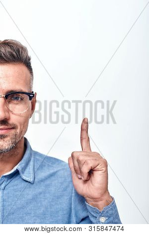 Look Here Half Face Portrait Of A Smiling Man With A Stubble In Eyewear Gesturing And Looking At Cam