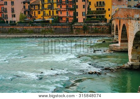 Roman Arch Bridge Over Adige River In Verona. Historical Center Of European City. Romantic Sightseen