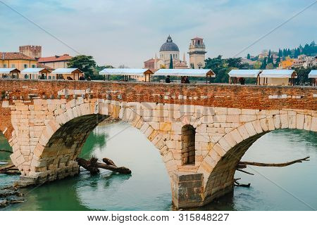 Roman Arch Bridge Over Adige River In Verona. Historical Center Of European City. Romantic Sightseen