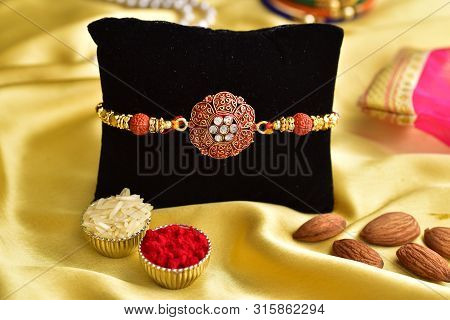 Creative Rakhi Photoshoot On Velvet Cushion In Golden Background, Raksha Bandhan Concept, Rakhi With