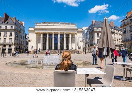 Nantes, France - May 12, 2019: Beautiful Woman Resting At An Outdoors Cafe On The Place Graslin Near