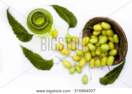 Neem Fruit Or Nim Fruit Or Indian Lilac Fruit In A Glass Bowl Isolated On White Along With Some Fres