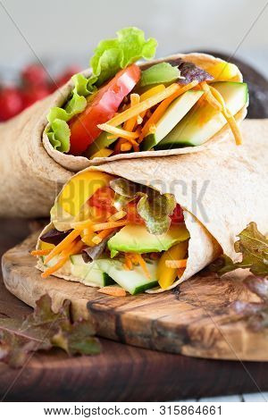A Healthy Lunch Or Dinner Of A Vegan / Vegetarian Wrap Made With  Argula Lettuce, Sliced Tomatoes, C