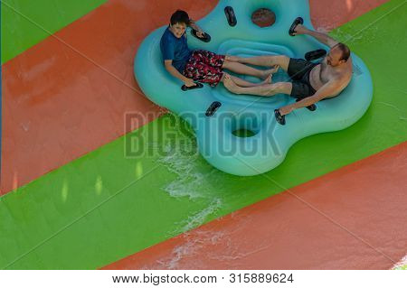 Orlando, Florida. July 29, 2019. People Enjoying Kare Kare Curl Water Attraction At Aquatica 14