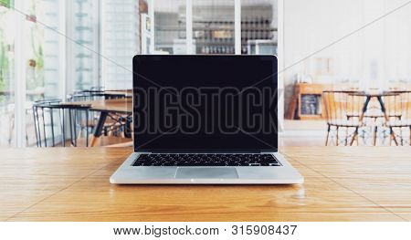 Laptop With Blank Screen On Table. Workspace Wood Desk With Laptop With Blank Screen, Laptop Showing