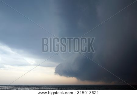 Dangery Thoundstorm In Dark Sky Coming With The Strong Storm Over Calm The Michigan Lake. Alone Bird