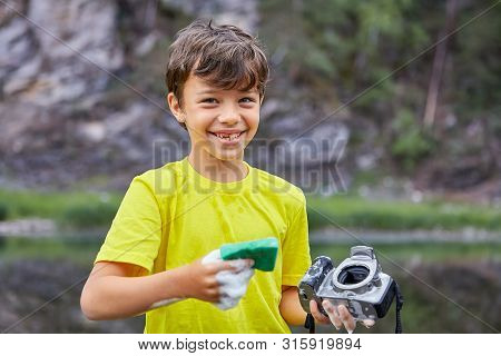 Joyful Naughty Boy Washes A Camera, Destroying It.