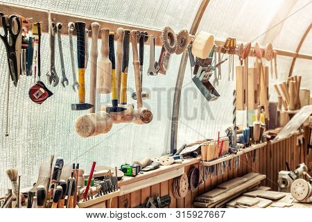 Woodwork Workshop Workbench With Many Different Tools And Equipment. Carpentry Craftsman Work Bemch.