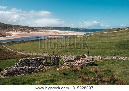 A Derelict Stone Farm Building Stands In Front Of The River Naver Where It Joins The Sea At A Desert