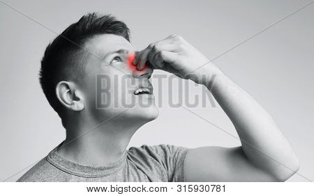 Haemophilia. Young Man Suffering From Nose Bleeding, Black And White Panorama
