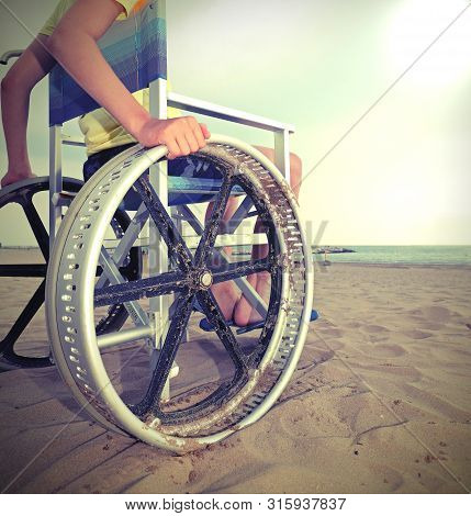 Detail Of A Special Wheelchair With Very Big Wheels To Move On The Sandy Beach Of The Resort With A 