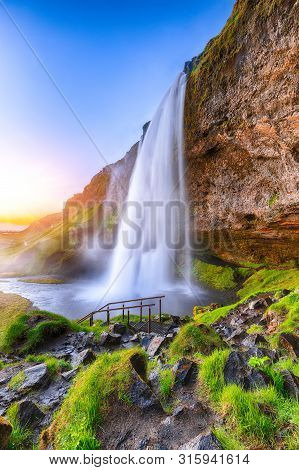Beautiful  Seljalandsfoss Waterfall In Iceland During The Sunset. Location: Seljalandsfoss Waterfall