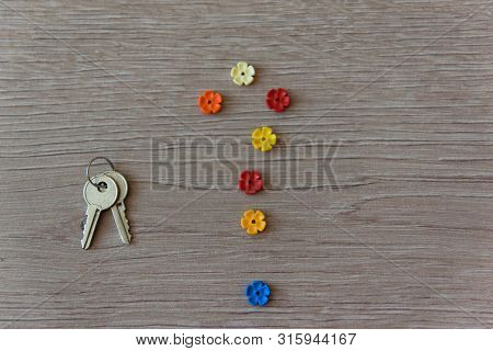 Question Sign From Colour Flowers And Iron Key On The Wood Background. Concept For Confusion, Questi