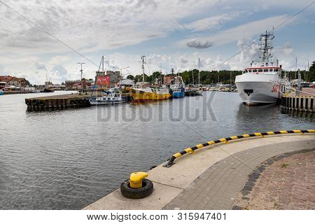 Ustka, Pomeranian / Poland - August 7, 2019: View Of The Fishing Port On The Baltic Sea. Harbor Buil