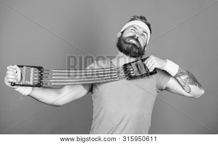 Sportsman Stretching Expander. Try Stretching Exercise. Athlete Workout With Expander. Improve Your 