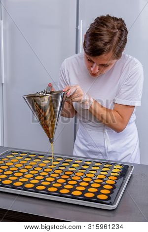 Pastry Chef In The Kitchen Makes Passion Fruit Confit. Cook Pours Passion Fruit Confit Into The Mold