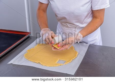 Pastry Chef In The Kitchen Makes Cookies. Cook Cuts Cookies From Rolled Dough Using A Cookie Cutter.
