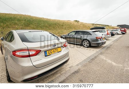 Overveen, Netherlands - Aug 16, 2018: Row Of Multiple Cars Parked On A Beach Park Space In Netherlan