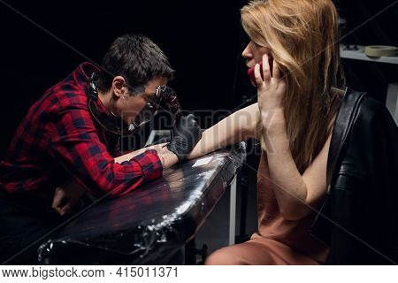 A Client Of A Professional Tattoo Artist Talks On The Phone While Making A New Painless Stick And Po