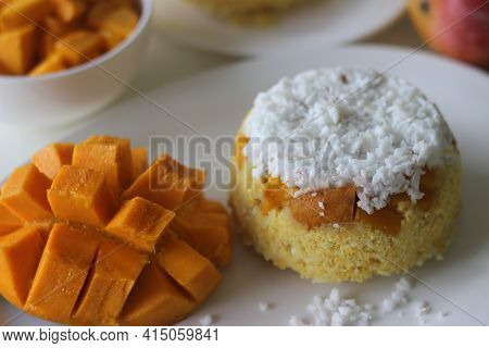 Steamed Ground Rice, Layered With Coconut Shavings And Mango. Locally Known As Mango Puttu. A Tradit