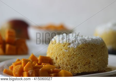 Steamed Ground Rice, Layered With Coconut Shavings And Mango. Locally Known As Mango Puttu. A Tradit