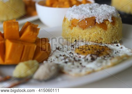 Steamed Ground Rice, Layered With Coconut Shavings And Mango. Locally Known As Mango Puttu. Served W