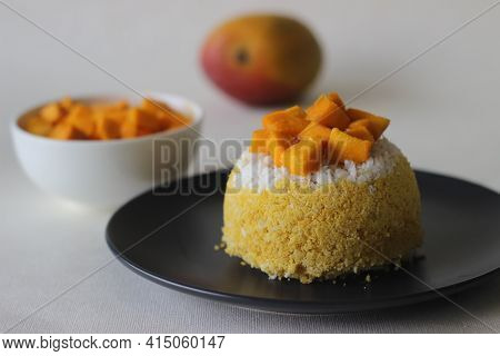 Steamed Ground Rice, Layered With Coconut Shavings And Mango. Locally Known As Mango Puttu. A Tradit