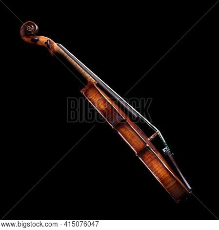 Side View Of A Baroque Violin Isolated On Black Background