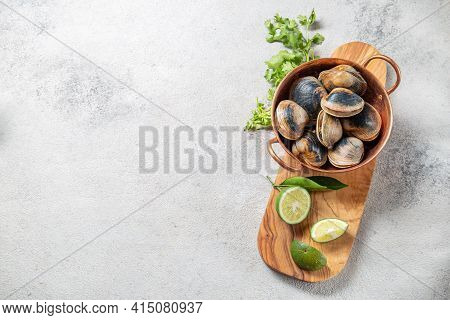 Raw Uncooked Clams Vongole Shells Shellfish With Ingredients For Cooking Coriandr, Beer And Lime In 