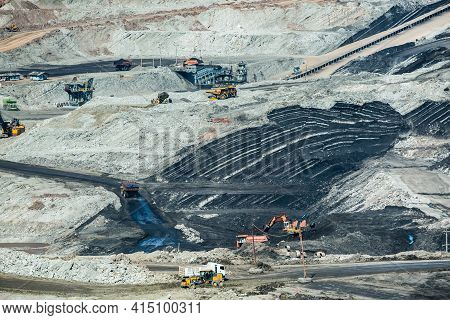 Mining Dump Trucks Working In Coalmine , Used As A Source Of Electricity Generation In The Country.