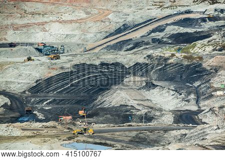 Mining Dump Trucks Working In Coalmine , Used As A Source Of Electricity Generation In The Country.