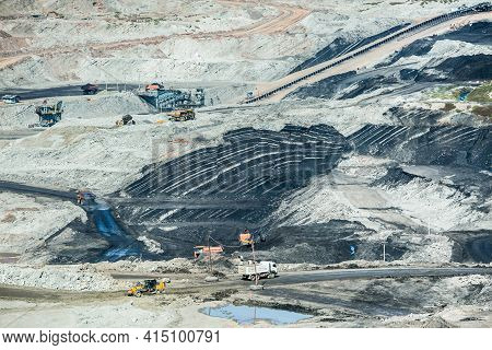 Mining Dump Trucks Working In Coalmine , Used As A Source Of Electricity Generation In The Country.