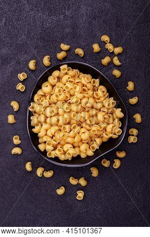 Traditional Dry Pasta On A Black Background. Design Concept. A Copy Of The Space. Selective Focus.